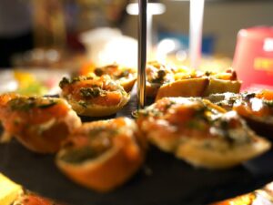 Small appetizers with salmon and herbs on a tiered stand.
